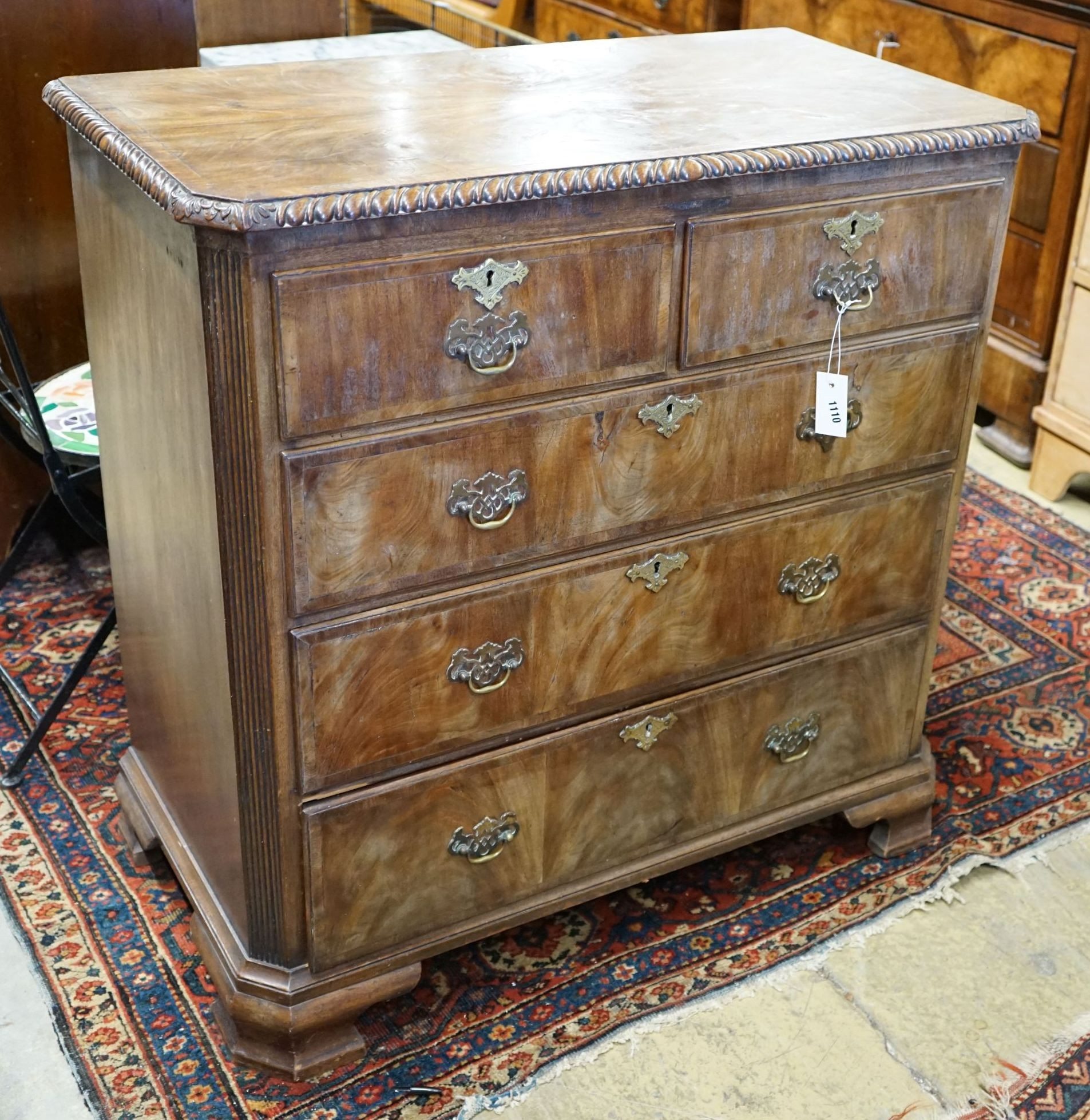 A George II style walnut chest with gadrooned top, width 98cm, depth 51cm, height 98cm